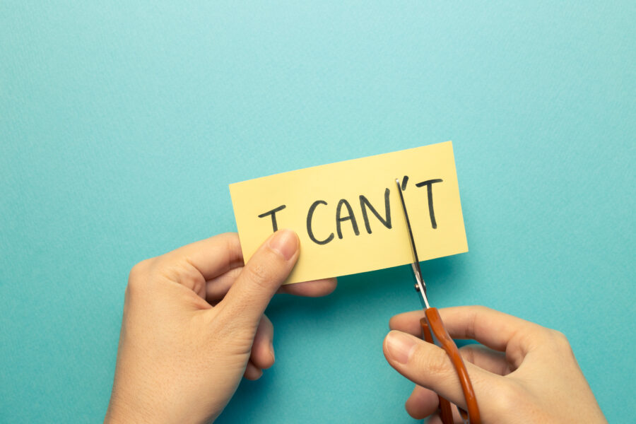I can do it. Positive motivation concept. Remove 't' from the word 'I can't' with scissors