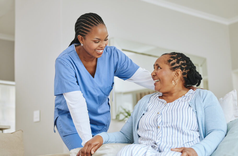 Nurse woman, senior patient and talking for support, healthcare and happiness at retirement home. Black person and happy caregiver together for trust, elderly care and help for health and wellness.